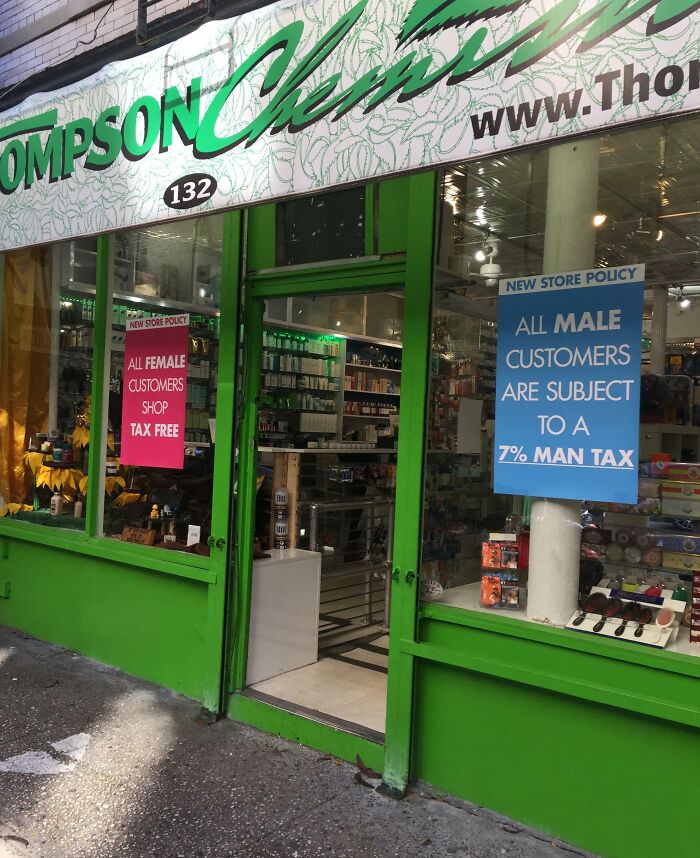 Green pharmacy entrance with signs showing different tax policies for male and female customers; infuriating local pharmacies.