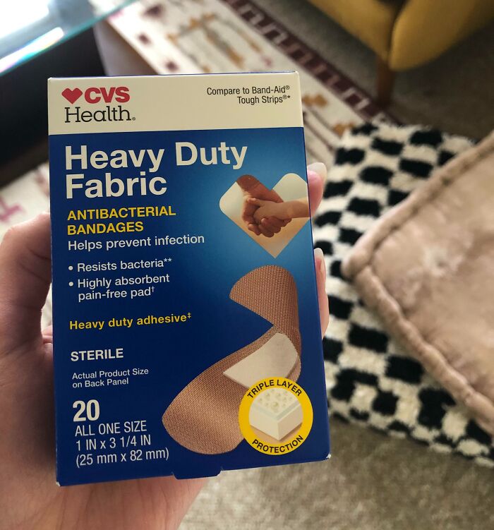 Close-up of CVS Health heavy-duty fabric bandages box, emphasizing antibacterial features; infuriating local pharmacies.