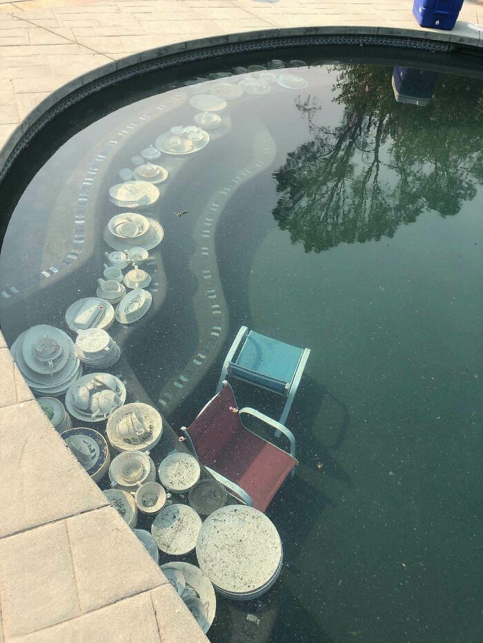 Debris and chairs submerged in a pool, illustrating nature disaster resilience.