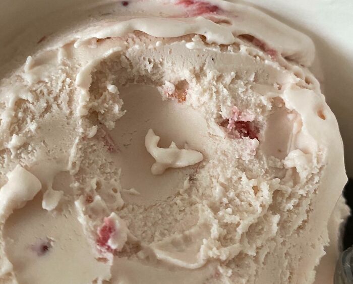 Ice cream with a small shape resembling a shark, showcasing pareidolia effects.