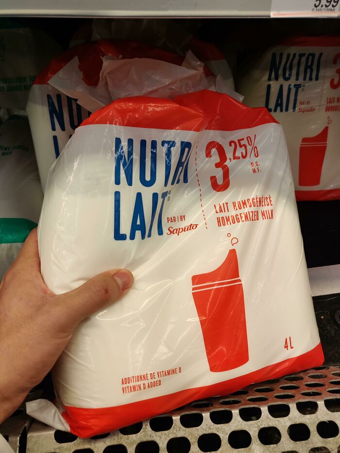 Bagged milk in a grocery store cooler, a peculiar thing normal in some countries but not globally.