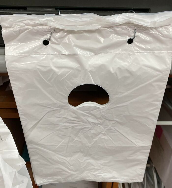 A plastic bag displaying a face-like image, exemplifying pareidolia with two dot eyes and a surprised mouth.