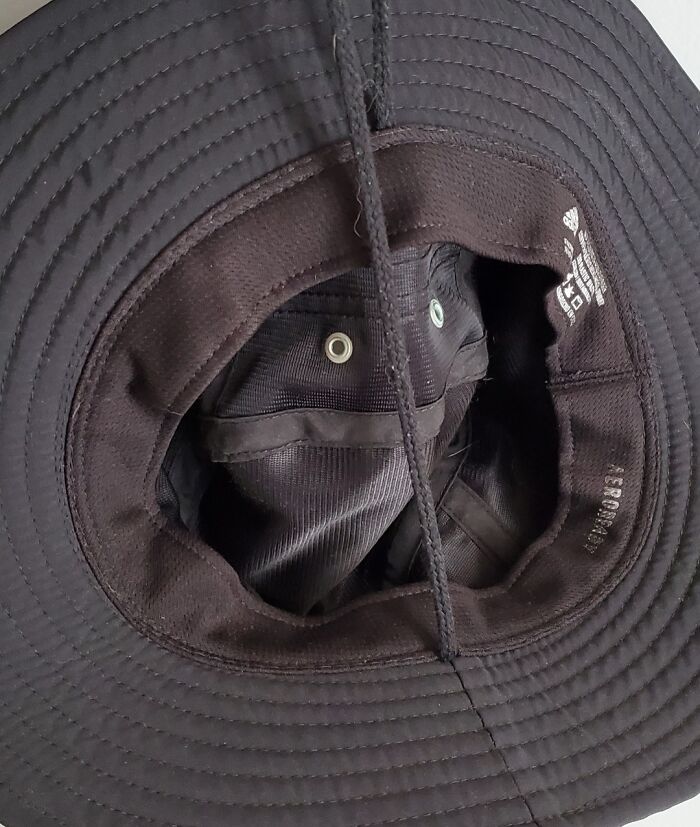 A black hat with an inner pattern resembling a face, demonstrating pareidolia.