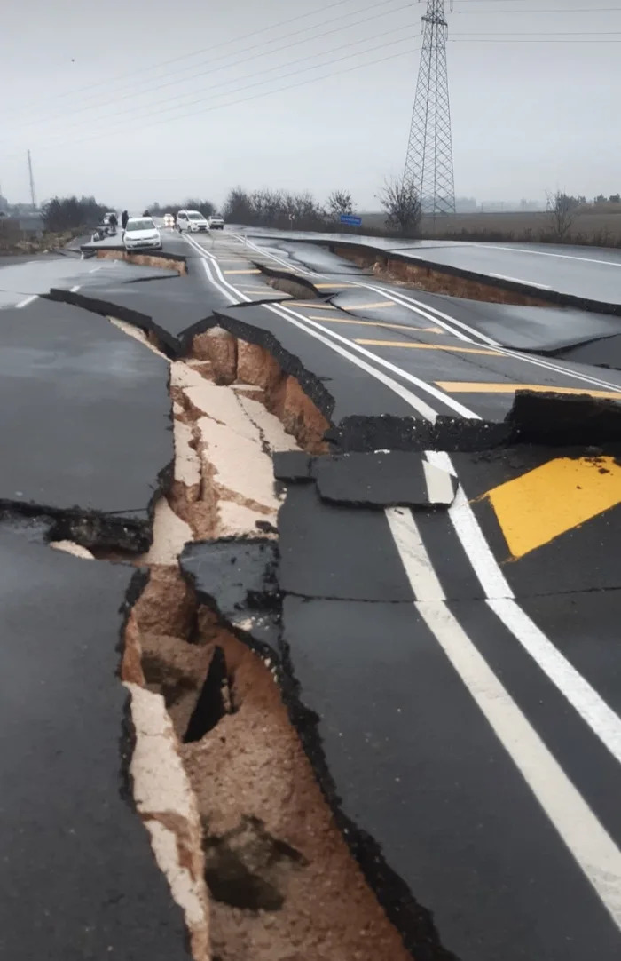 C*****d road from earthquake showcasing nature disaster resilience challenges.