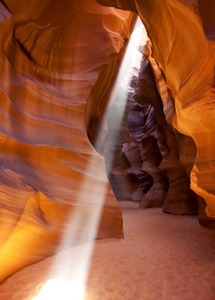 Sunbeam illuminating Antelope Canyon's stunning rock formations, showcasing amazing views in certain states.