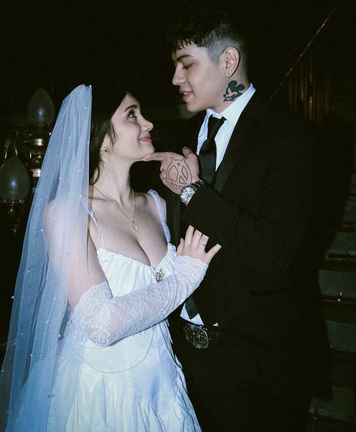 Couple in wedding attire gazing lovingly at each other, showcasing long-distance love.