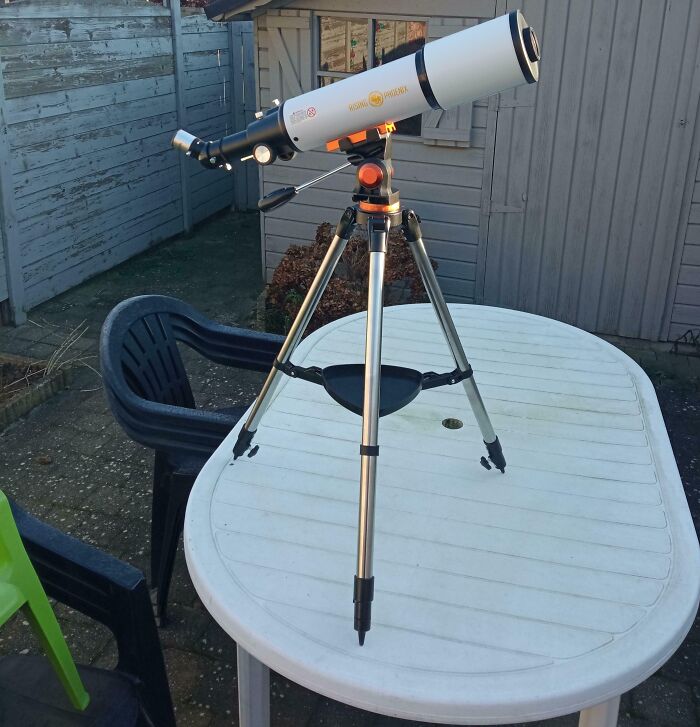 Telescope set up on a patio table, ready for stargazing as a funny wholesome anniversary surprise.