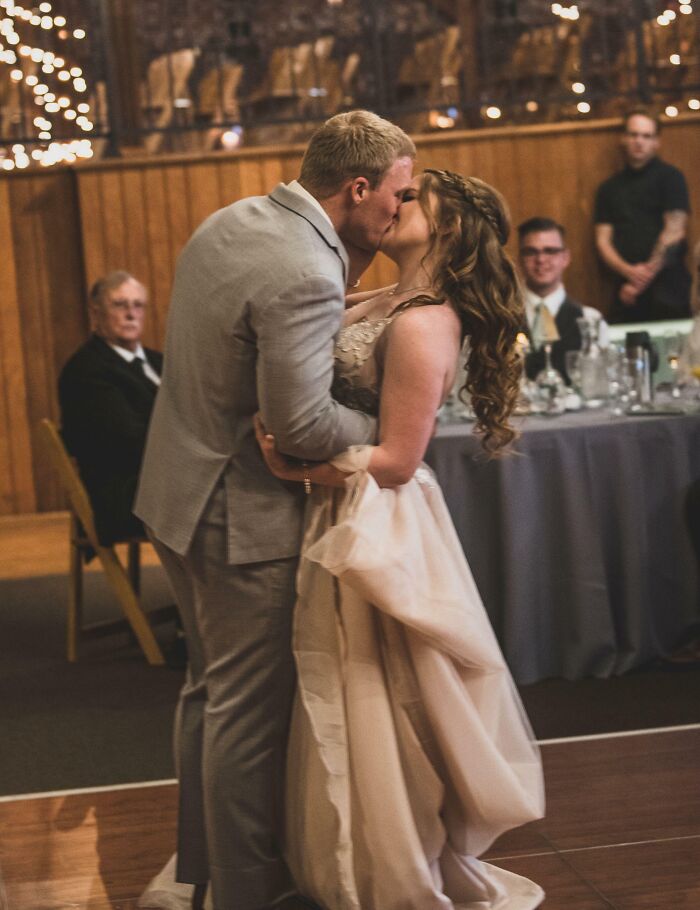 A couple sharing a romantic kiss at their wedding, demonstrating that love always wins.