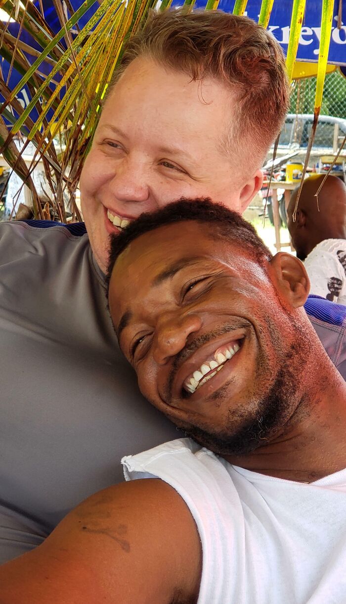 Two people smiling together, showing joy and proving love always wins.