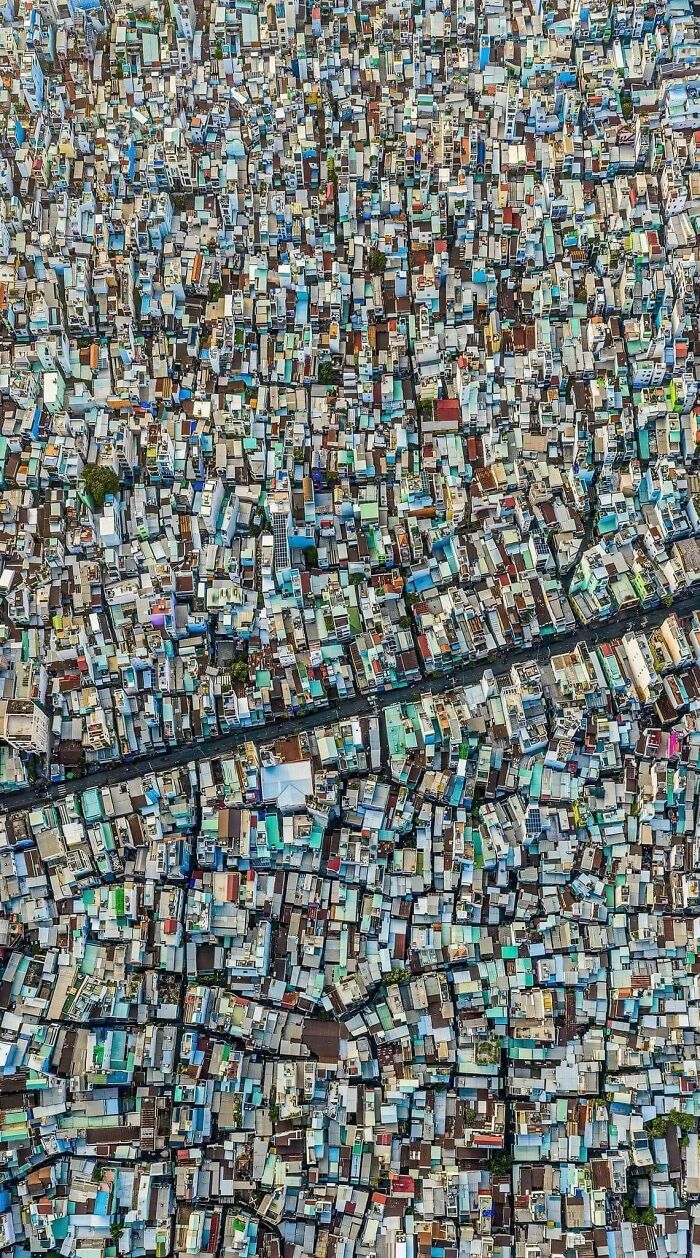 Aerial view of dense urban hell with crowded buildings forming a chaotic pattern.