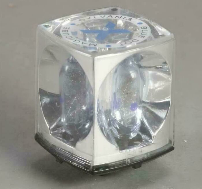 Vintage Sylvania magicube blue dot light bulb encased in clear plastic, a nostalgic collectible from past decades.
