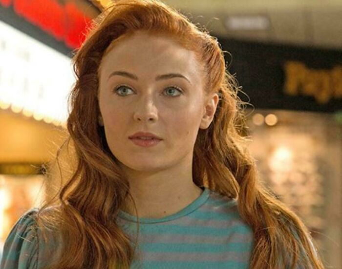 Young woman with long red hair and blue striped shirt, featured in a scene highlighting questionable movie details for cinephiles.