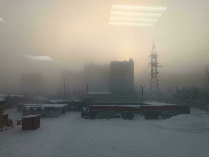 Foggy urban landscape with snow and power lines, illustrating nature-disaster-resilience.