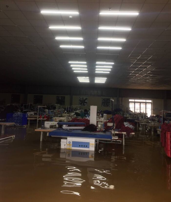 Flooded factory interior, highlighting nature disaster resilience efforts in impacted areas.