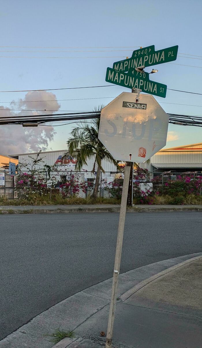 Worn-down stop sign illustrating the passage of time, with street signs in the background at an intersection.