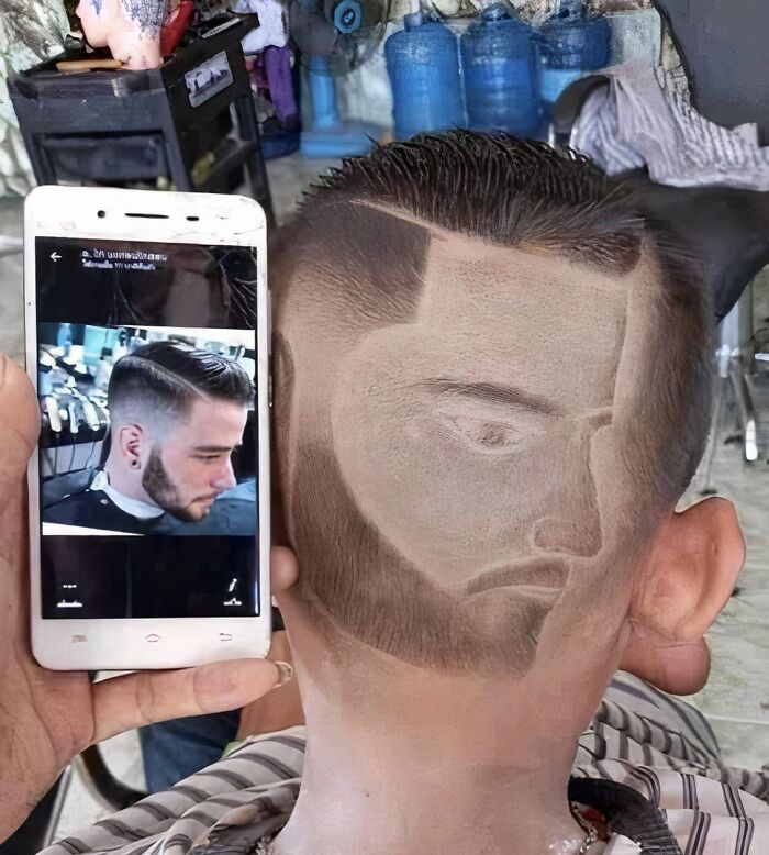 Creative haircut with a face design on the back of the head, showcasing a unique hair accident in a humorous style.