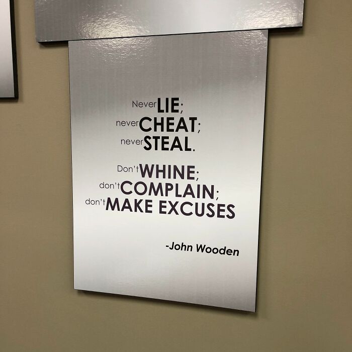 A badly placed inspirational poster in an office setting, highlighting unfortunate public interior designs.
