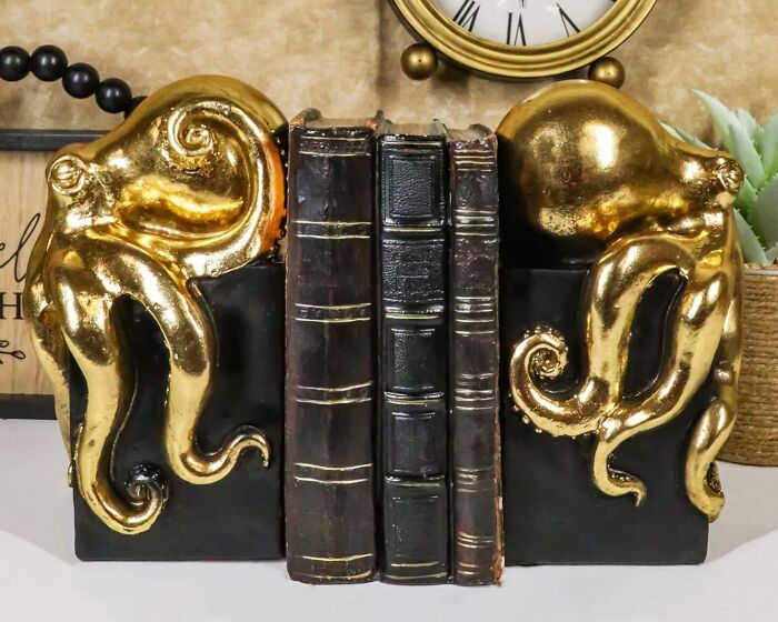 Gold octopus bookends holding vintage books, showcasing dopamine decor style.
