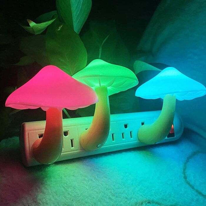 Colorful mushroom lights plugged into an outlet, creating a whimsical dopamine decor effect.