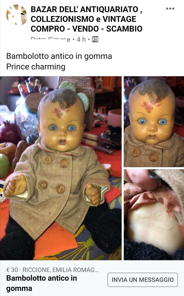 Creepy antique rubber doll for sale online, wearing a vintage coat with blue eyes.