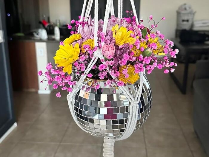Vibrant flowers in a disco ball planter, embodying dopamine decor aesthetics with a lively and colorful display.