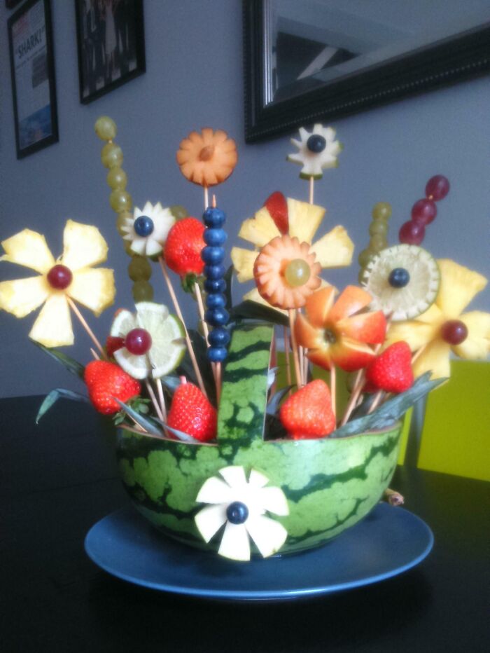 Colorful fruit arrangement in a watermelon basket, perfect for funny wholesome anniversary surprises.