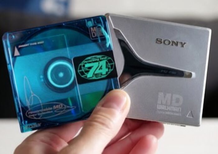Sony MiniDisc player held in hand, showcasing a historical invention ahead of its time.