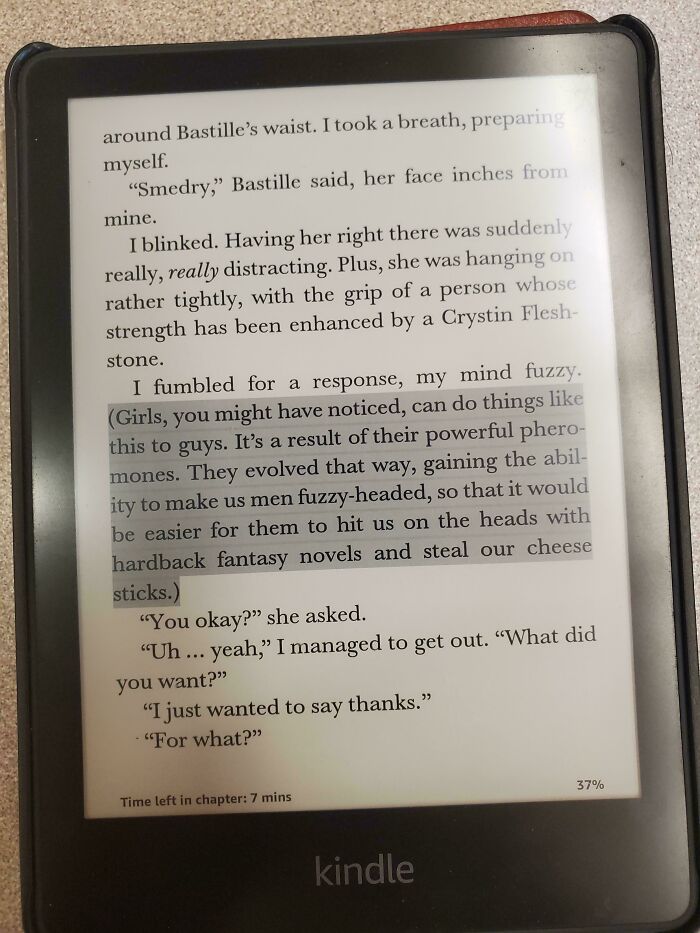 E-reader displaying text humorously highlighting male authors' misunderstanding of women and pheromone effects.