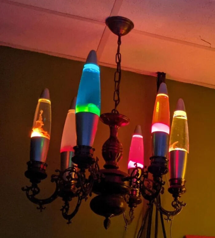 Vintage chandelier with colorful lava lamps as bulbs creating a DIY disaster in home lighting decor.
