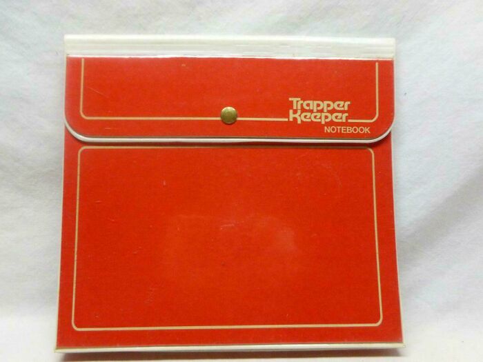 Vintage red Trapper Keeper notebook, a nostalgic photo symbolizing school supplies from past decades.