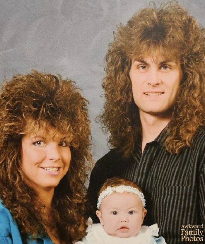 Family photo with 1980s hairstyles, featuring parents and baby, capturing awkward yet sweet family memories.