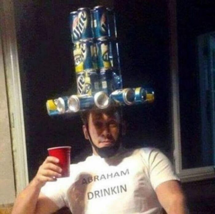 Man wearing a beer can hat and a shirt that says Abraham Drinkin, holding a red cup, showing weird side of the internet.