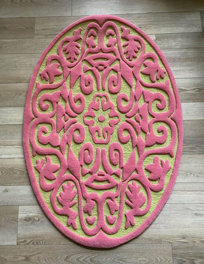 Colorful DIY project featuring a round rug with intricate pink patterns on a wooden floor.