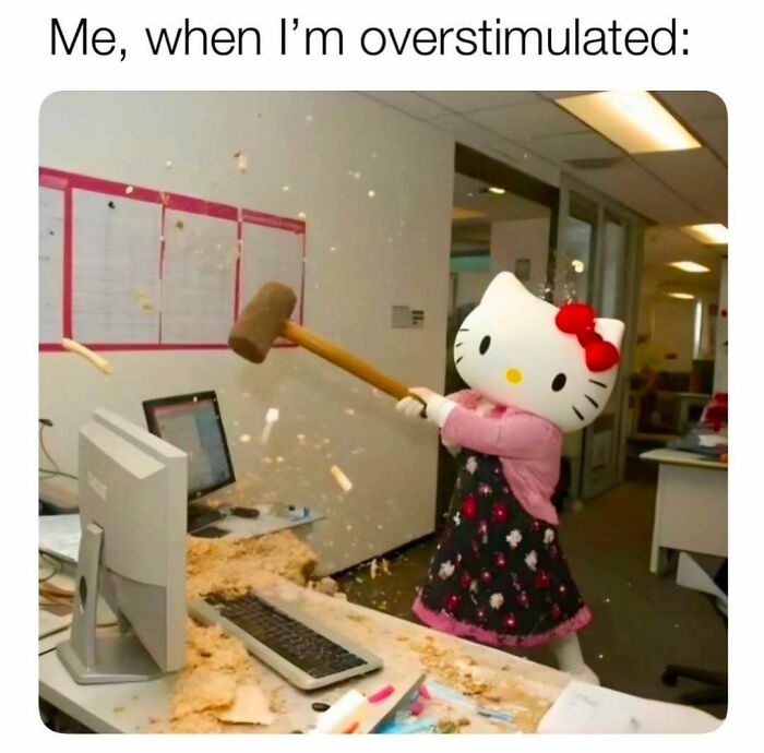 Person wearing a Hello Kitty costume smashing a computer with a mallet in an office, illustrating humor as a coping mechanism.