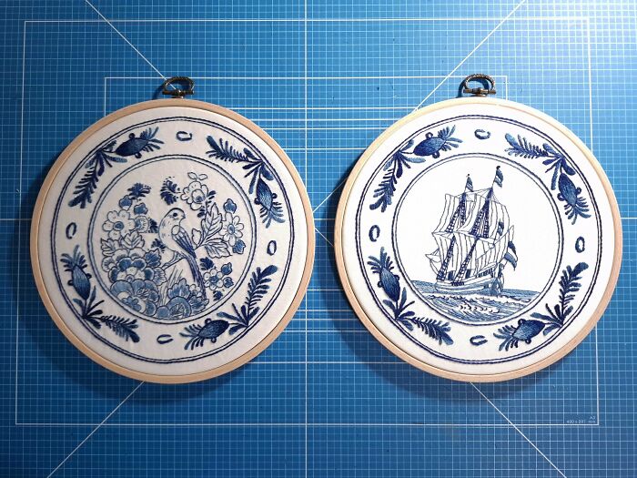 Two blue and white embroidery designs featuring a bird and a sailing ship, displayed on a grid background.
