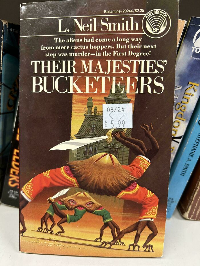 Terrible book cover of "Their Majesties' Bucketeers" featuring unusual creatures and a historical building.