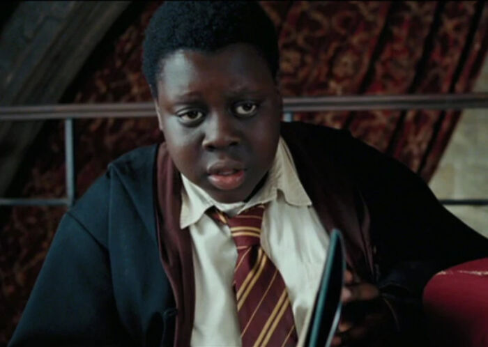 Young boy in a movie scene wearing a school uniform and robe, illustrating questionable movie details for cinephiles to mock online