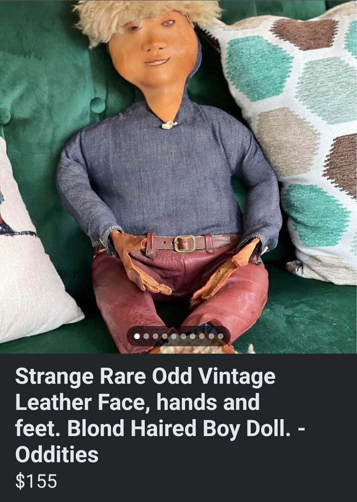 Vintage doll with leather face, sitting on a couch, listed as a creepy collectible online for $155 in Burlington, CT.