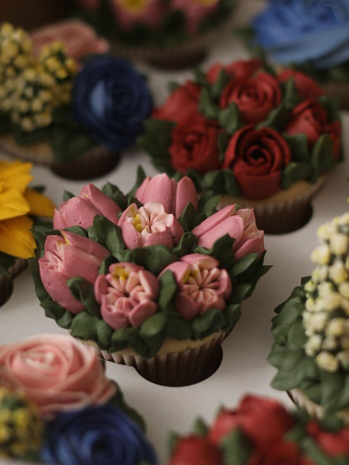 Cupcakes decorated with icing flowers, showcasing bakers' culinary creativity at a whole other level.
