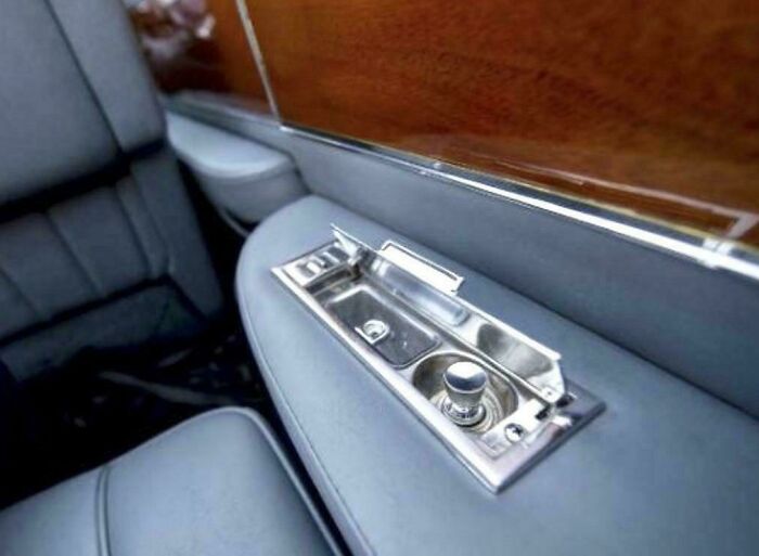 Vintage car door panel with ashtray and window controls in classic retro interior, evoking nostalgic photos and memories.