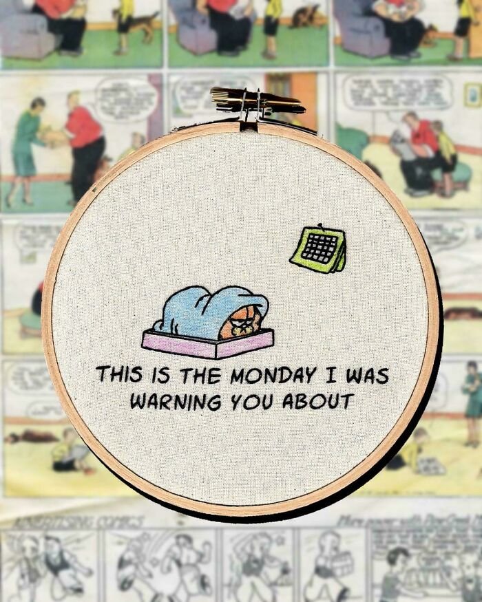 Embroidery hoop featuring a cute embroidery of a cat in bed with a calendar and a Monday warning message.