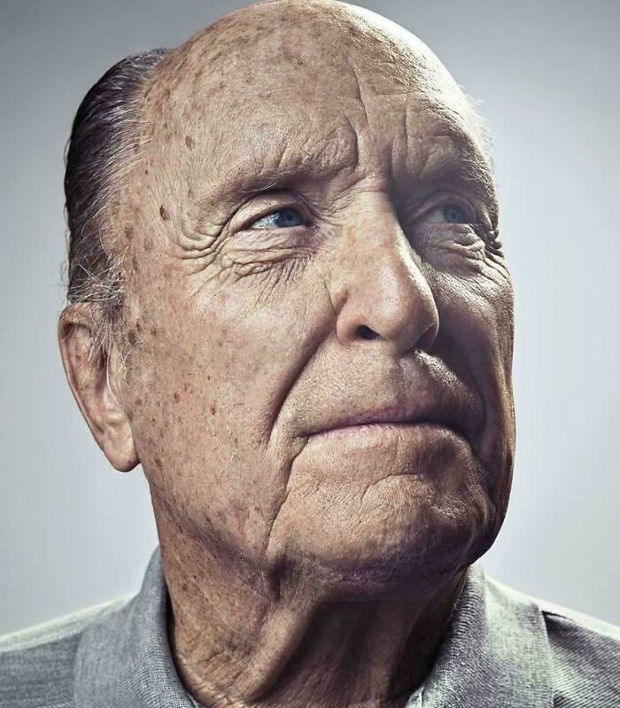 Elderly man with wrinkles and thoughtful expression, evoking memories of the past and childhood reflections.