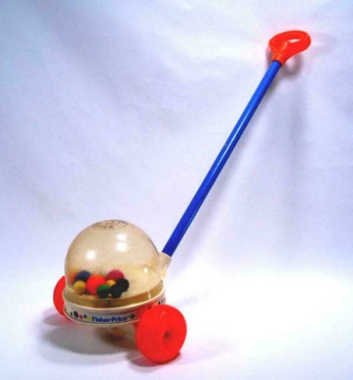 Vintage Fisher-Price popper toy with red wheels and blue handle, evoking childhood nostalgia.
