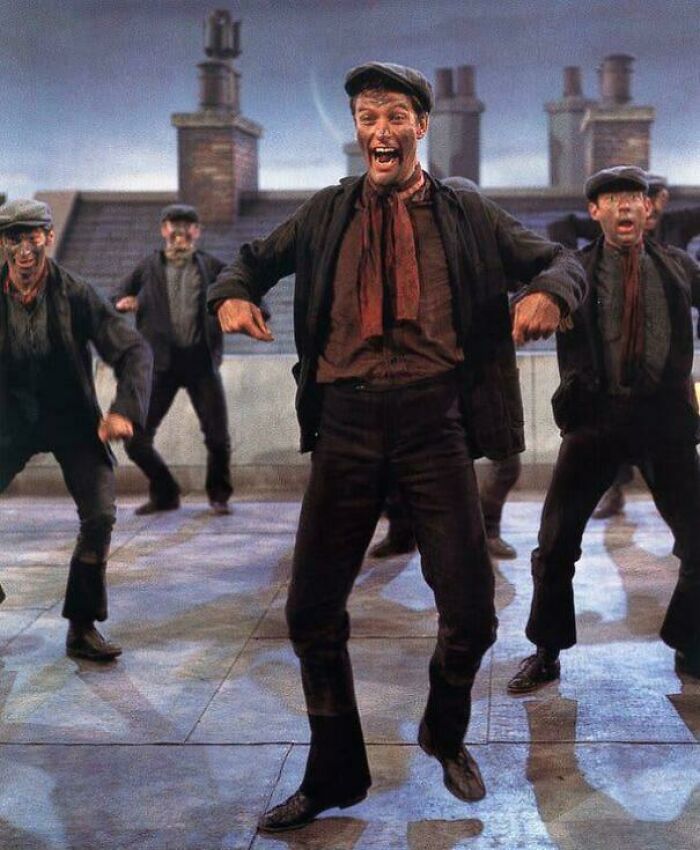 Dancers in vintage attire performing energetically on a rooftop, evoking childhood nostalgia.