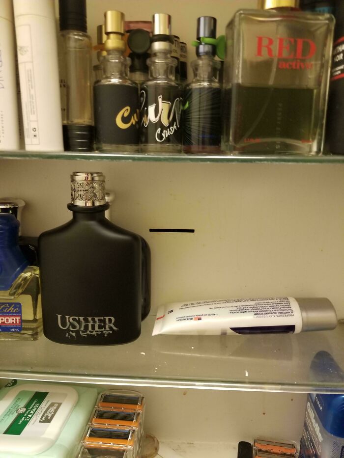 Cologne and toiletries on a shelf, evoking childhood memories of familiar scents and past grooming routines.