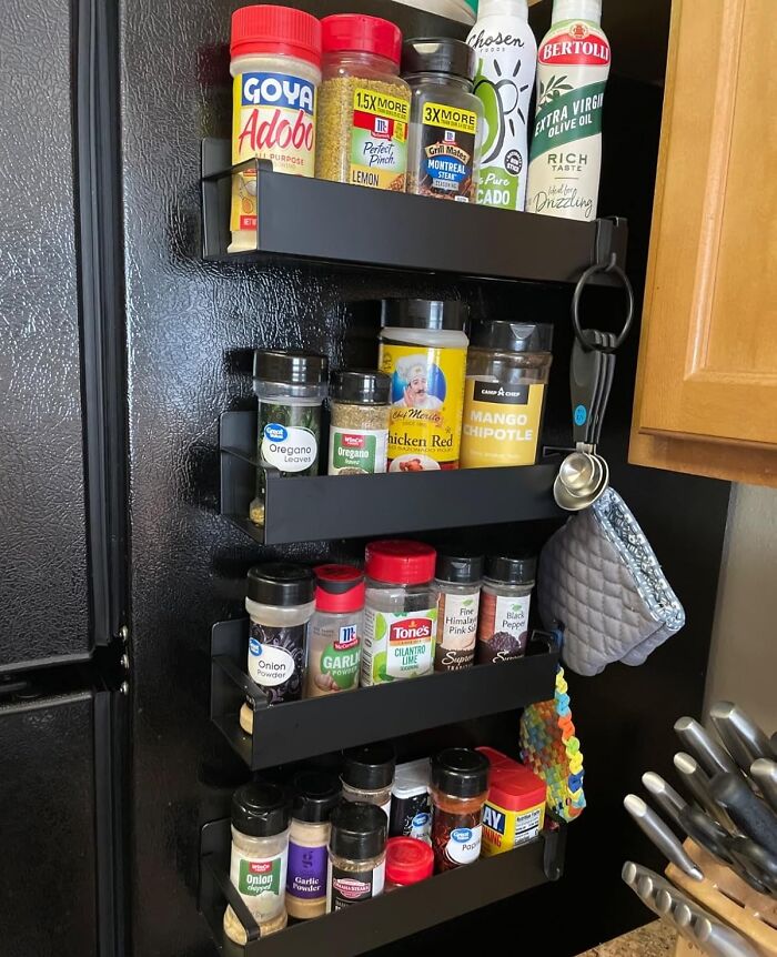 Wall-mounted spice organizer with jars and cooking essentials, a highly praised home find.