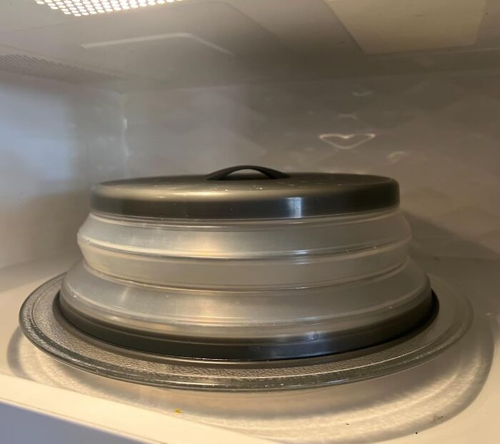 Microwave cover, a popular every home find, inside a microwave, showcasing its practical use for containing splatters.
