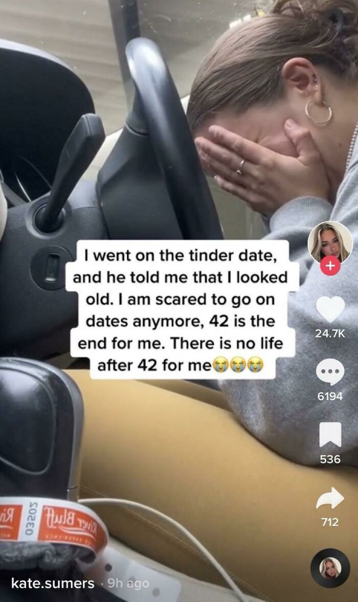 Woman covering her face in a car during an awkward date moment, feeling discouraged after a comment about age.