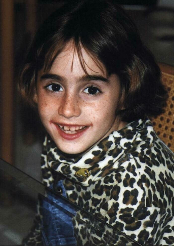 Child wearing a leopard print turtleneck, smiling at the camera, part of a true crime stories collection.