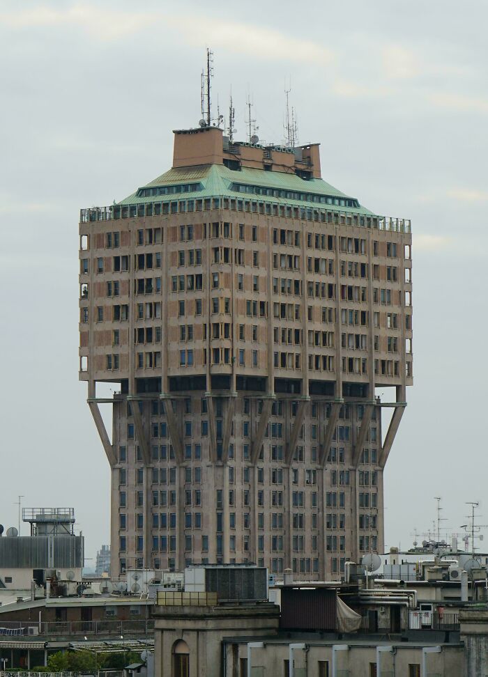 Unusual architecture of an urban building on stilts, conveying an urban hell aesthetic.